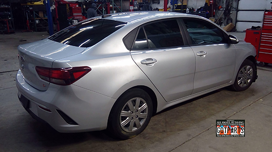 A salvage silver Kia Rio sedan, a source for quality used OEM parts for your Kia repair.